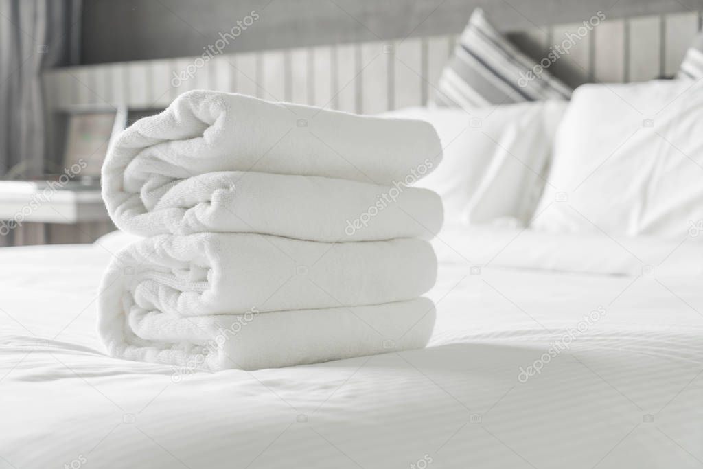 White towel on bed decoration in bedroom interior 
