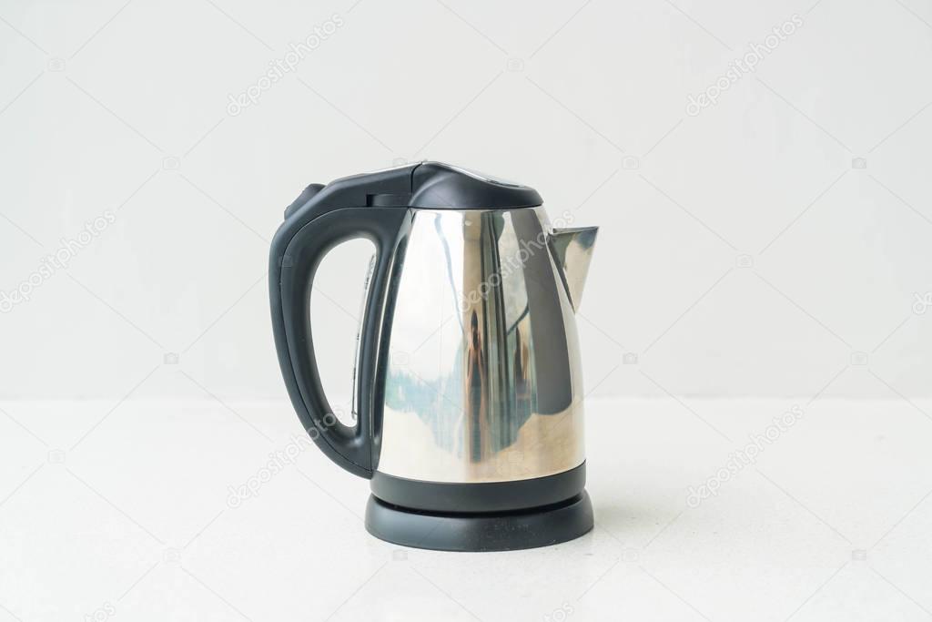 kettle and cup  on wall background