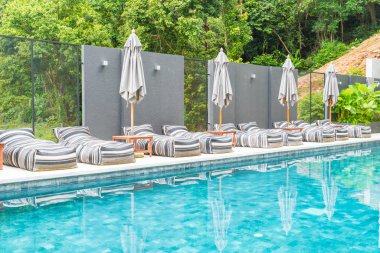 Güzel lüks şemsiye ve sandalye etrafında Açık Yüzme Havuzu