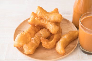 derin yağda kızartılmış hamur sopa ile süt çay