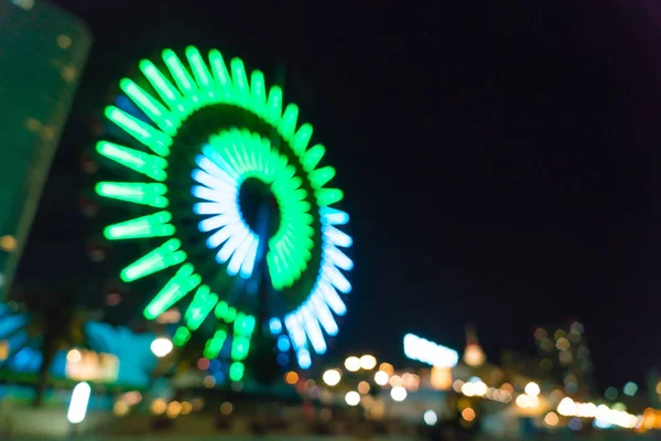 Suddig bokeh natt harbor lights bakgrund med pariserhjul — Stockfoto