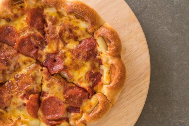 Ev yapımı biberli Pizza ahşap plaka üzerinde