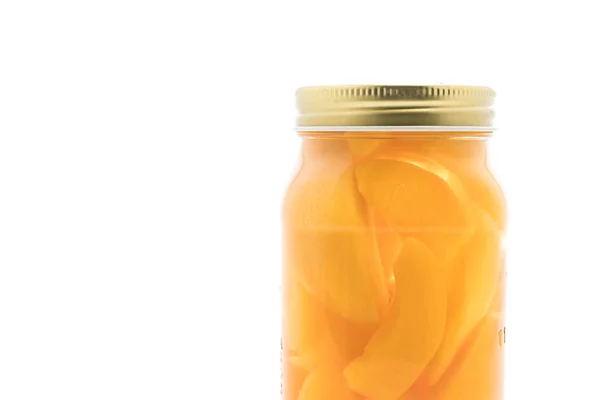 Peach in bottle on white — Stock Photo, Image