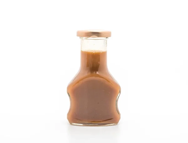 Caramel bottle sauce on white — Stock Photo, Image