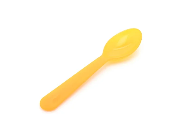 Yellow plastic spoon — Stock Photo, Image