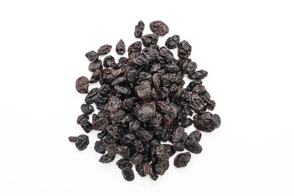 Black raisins on white — Stock Photo, Image