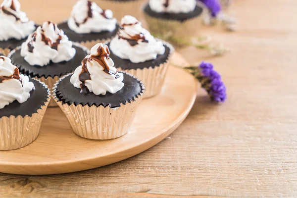 Chocolate cup cake with whipped cream — Stock Photo, Image