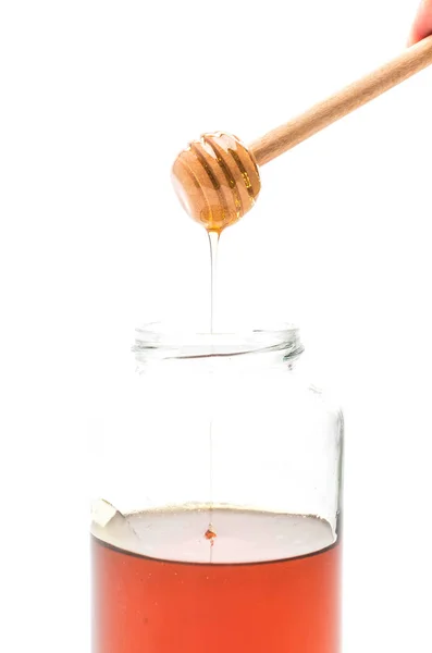 Goteo de miel en frasco — Foto de Stock