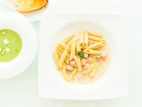 Penne carbonara pasta with salmon — Stock Photo, Image