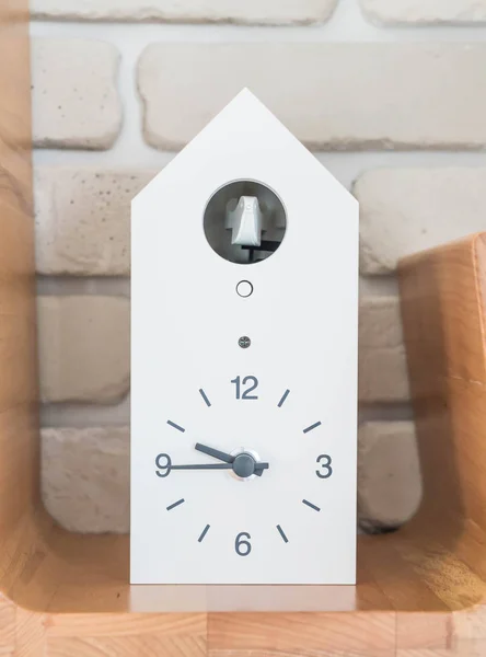 clock on wood shelf