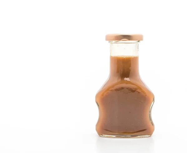 Fles van de karamel saus op wit — Stockfoto