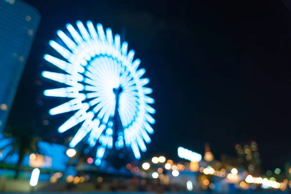 Suddig bokeh natt harbor lights bakgrund med pariserhjul — Stockfoto