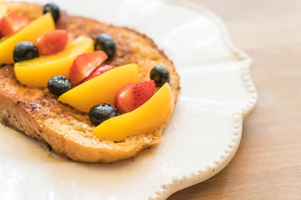 french toast with peach, strawberry and blueberries