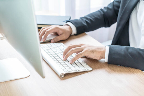 Close-up hand of businessman using computer