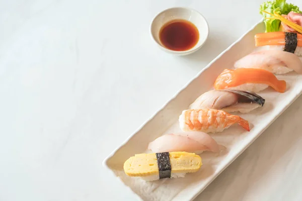 Raw and fresh nigiri sushi in white plate — Stock Photo, Image