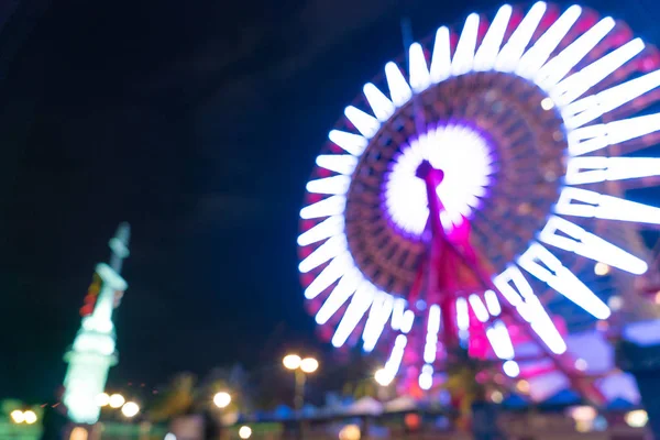 Bokeh rozostřeného noční přístav světla pozadí s ruské kolo — Stock fotografie