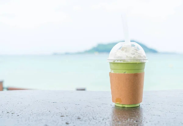 iced greentea cup with sea background