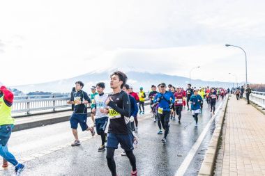 Kawaguchiko, JAPAN - Nov 27, 2016: People running on the bridge  clipart
