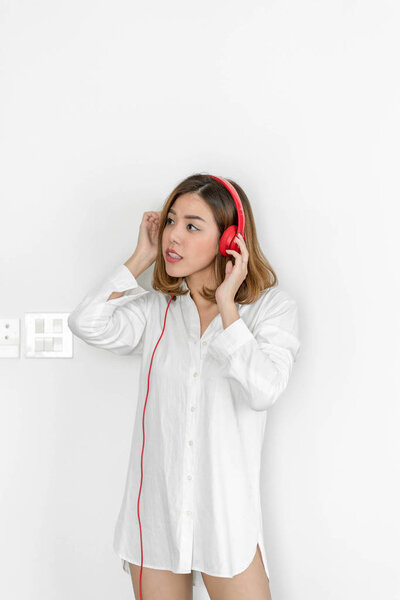Young beautiful woman listening music with headphones