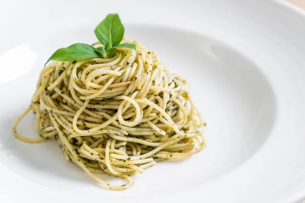 Pasta spaghetti with pesto green sauce and basil — Stock Photo, Image