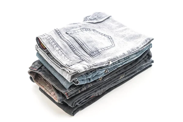 Pila de jeans doblados sobre fondo blanco — Foto de Stock