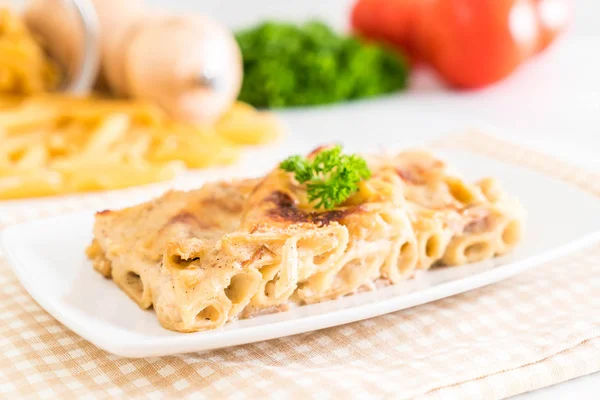 Baked penne pasta with cheese and ham — Stock Photo, Image