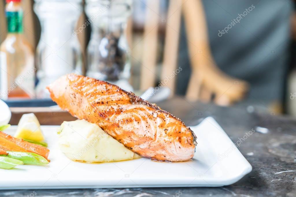 salmon steak with mash potato and vegetable