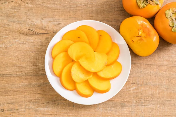 Sliced persimmon on plate — Stock Photo, Image
