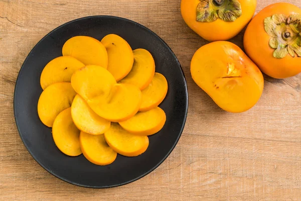 Sliced persimmon on plate — Stock Photo, Image