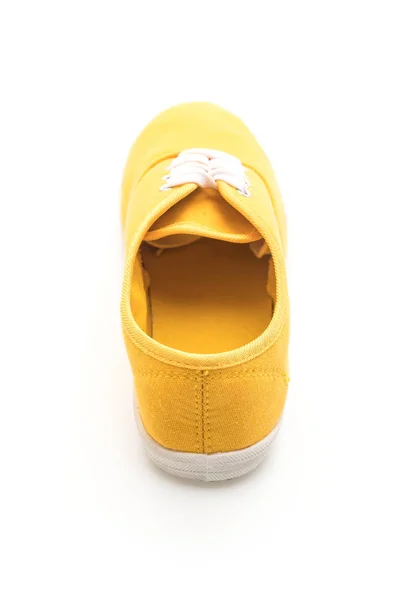 Gele sneakers op witte achtergrond — Stockfoto