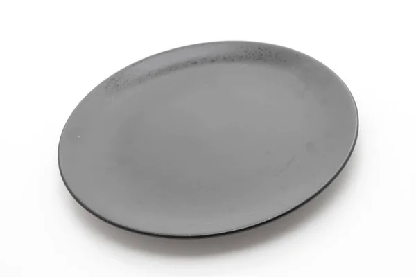 Schwarzer Teller auf weißem Hintergrund — Stockfoto