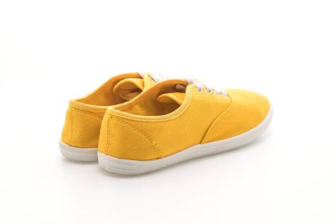 beyaz zemin üzerine sarı spor ayakkabı