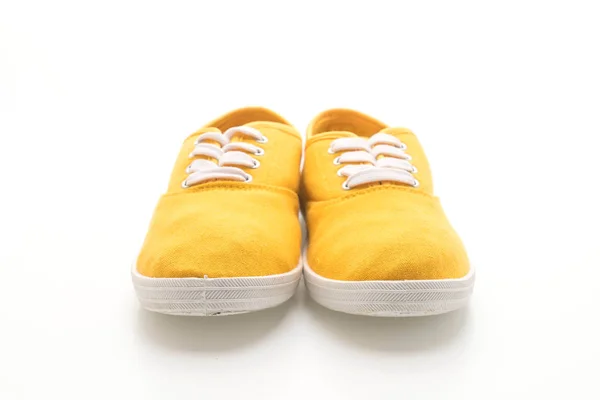 Sapatilhas amarelas no fundo branco — Fotografia de Stock