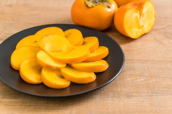 Sliced persimmon on plate — Stock Photo, Image