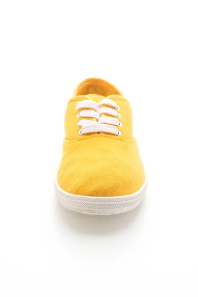 Желтые кроссовки на белом фоне — стоковое фото
