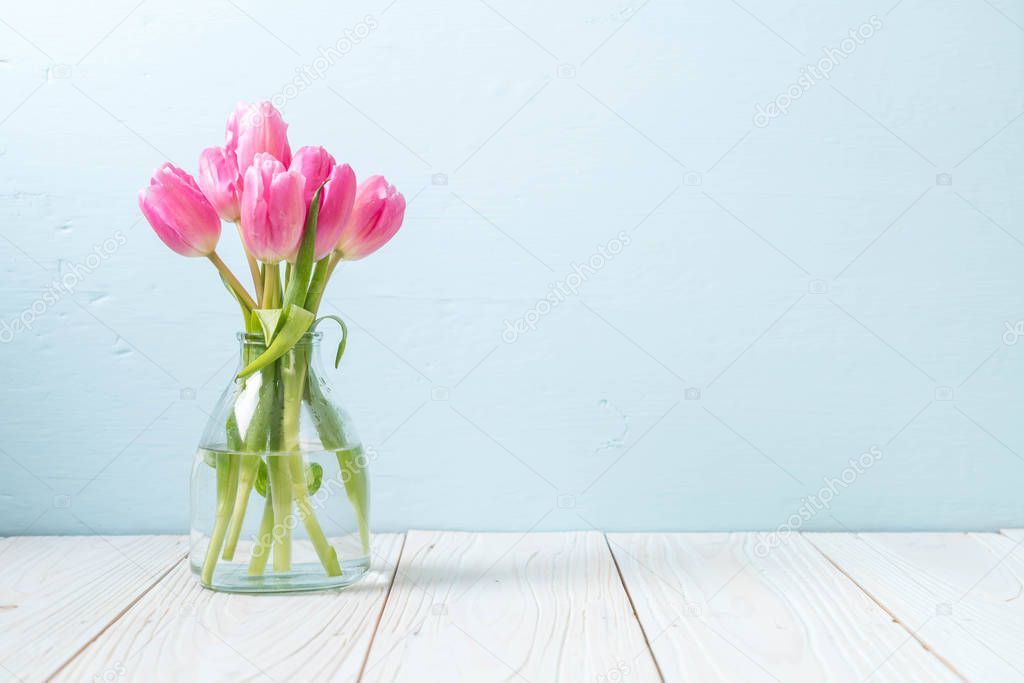pink tulip flower on wood background with copy space