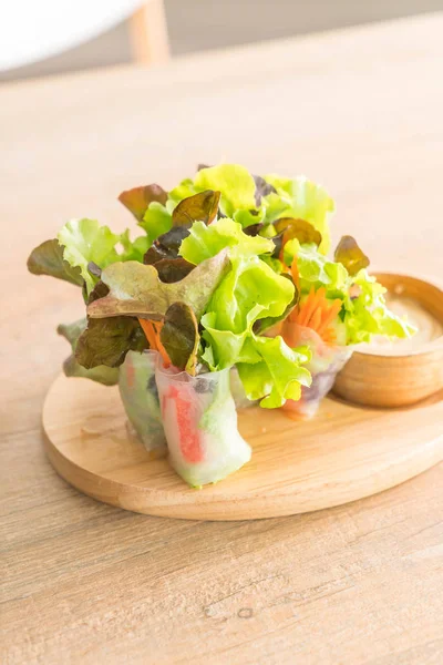 Rotolo di insalata su piatto di legno — Foto Stock