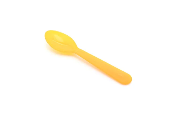 Yellow plastic spoon — Stock Photo, Image