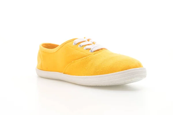 Gele sneakers op witte achtergrond — Stockfoto