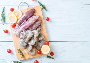 taze deniz ürünleri ham (karides, mürekkep) ahşap tahta üzerinde 