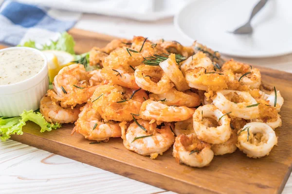 Fried seafood (squids, shrimps, mussels) with sauce — Stock Photo, Image