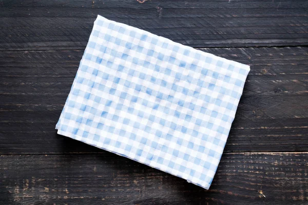 kitchen cloth (napkin) on wood background