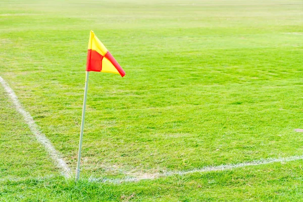 corner flag in green football field