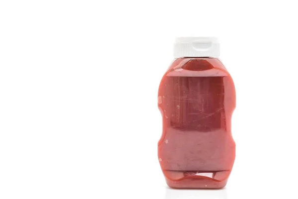 Kečupovou sklenicí na bílém pozadí — Stock fotografie