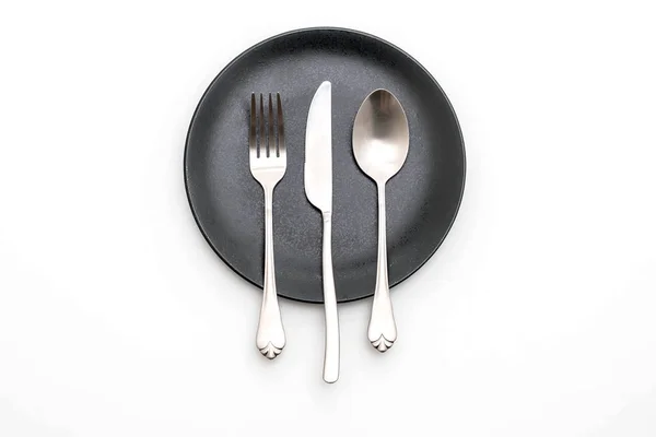 Empty plate spoon fork and knife — Stock Photo, Image