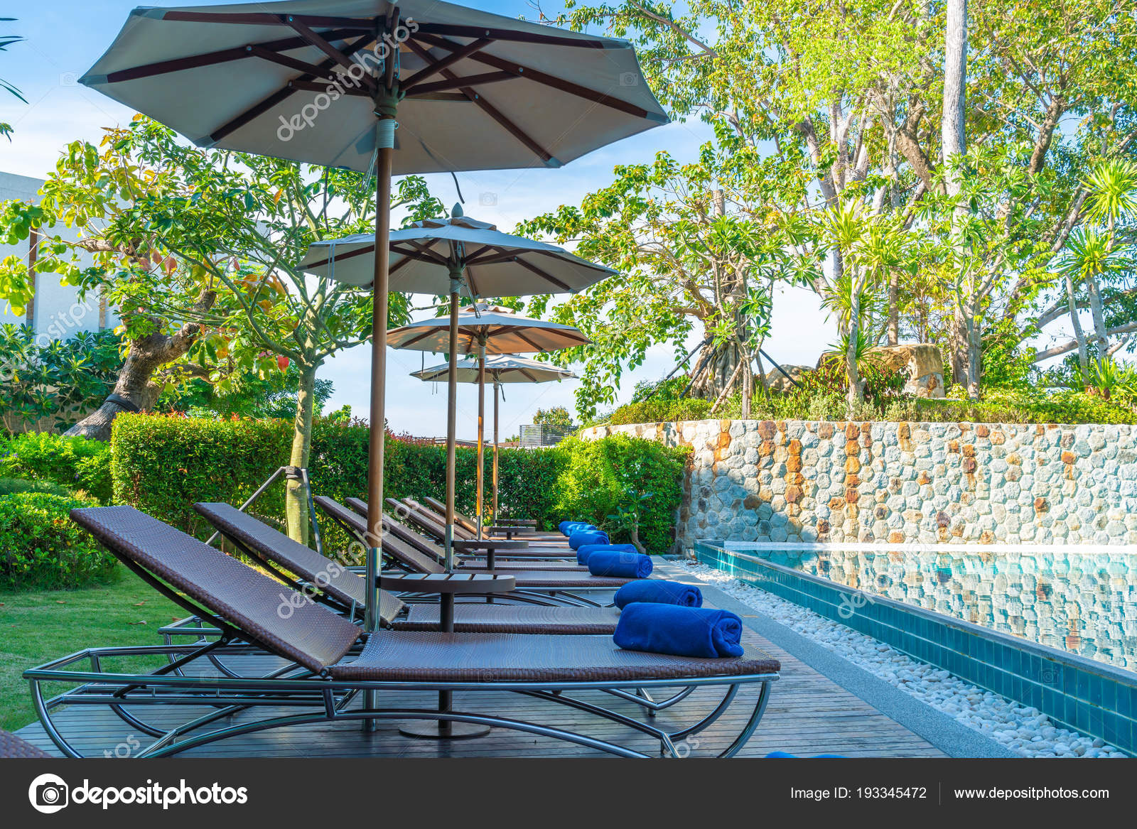 Beautiful Umbrella And Chair Around Swimming Pool In Hotel
