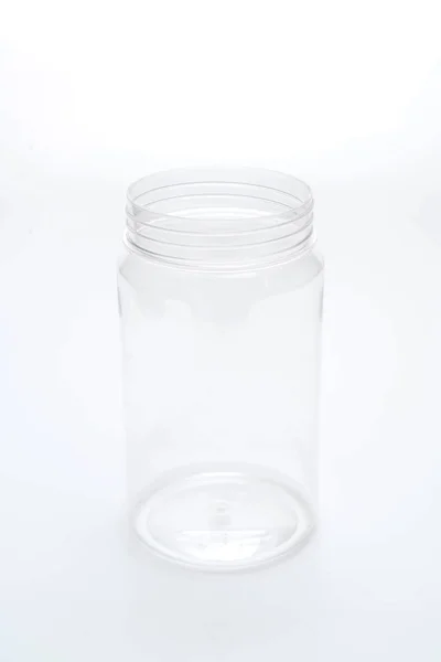 Frasco de plástico vazio no fundo branco — Fotografia de Stock