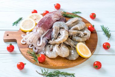 taze deniz ürünleri ham (karides, mürekkep) ahşap tahta üzerinde 