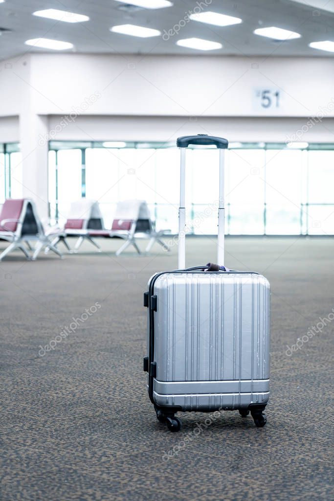 traveler suitcases in airport terminal 