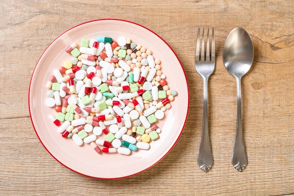pills ,drugs ,pharmacy ,medicine or medical on plate - healthycare concept